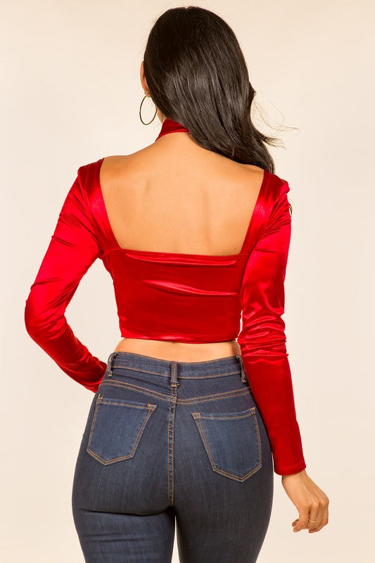 a woman wearing a red top and jeans