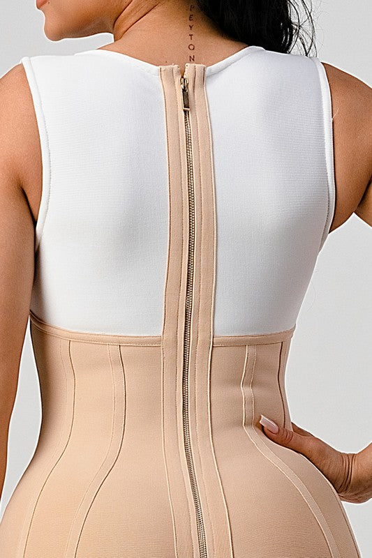 a woman wearing a beige bodysuit with zippers