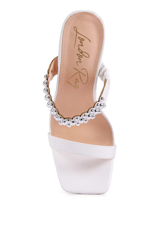 a women's white high heeled sandal