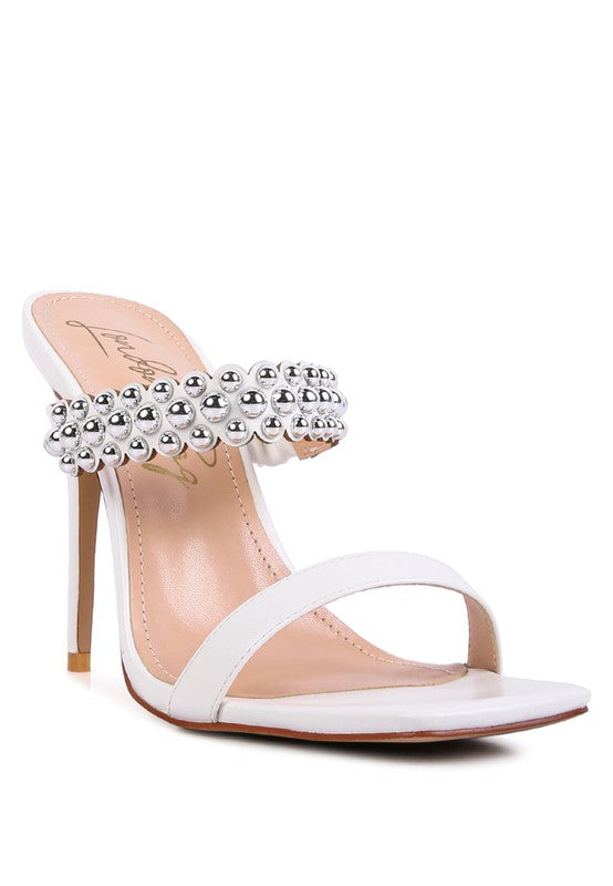 a women's white high heeled sandal with a jewel embellishment