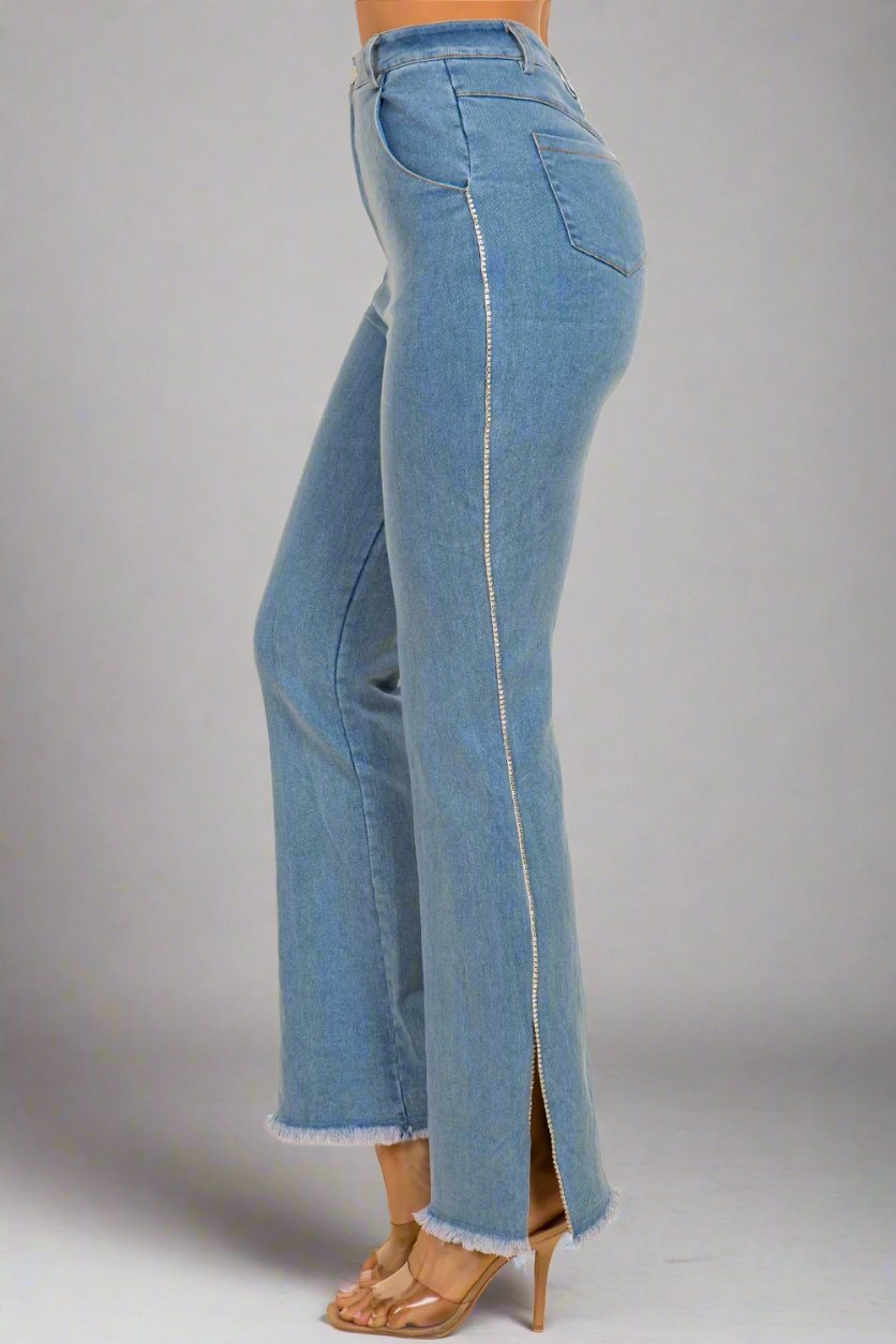 a woman wearing a pair of jeans with a side slit