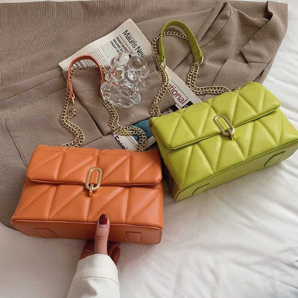 a handbag and a purse sitting on a bed