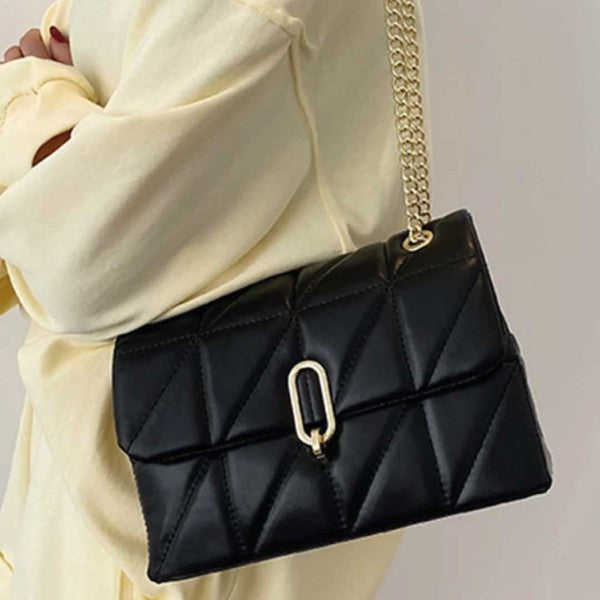 a woman carrying a black quilted purse