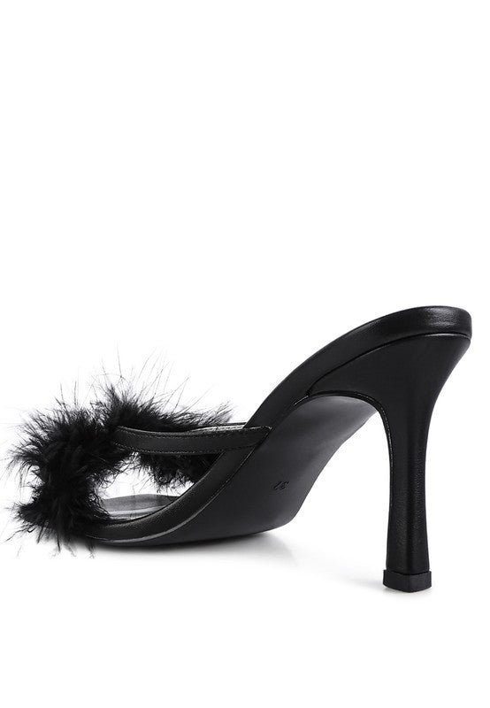 a black high heeled shoe with a furry heel