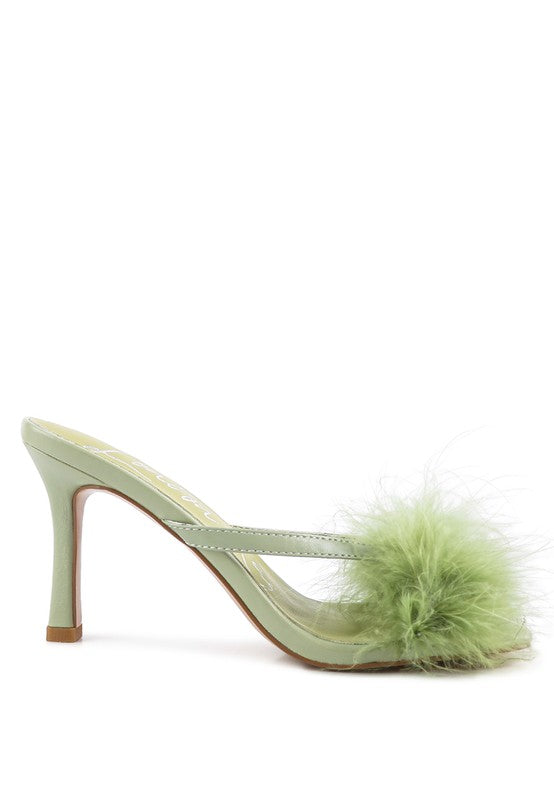 a pair of green shoes with a fur ball on the heel