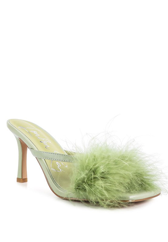 a pair of green shoes with a furry heel