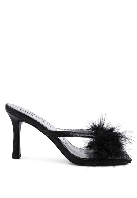 a black shoe with a fur ball on the heel