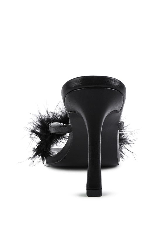 a black high heeled shoe with feathers on the heel