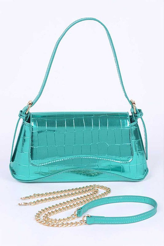 a green purse with a chain hanging from it