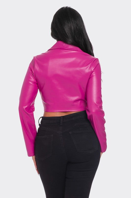 a woman wearing a pink leather jacket and black pants