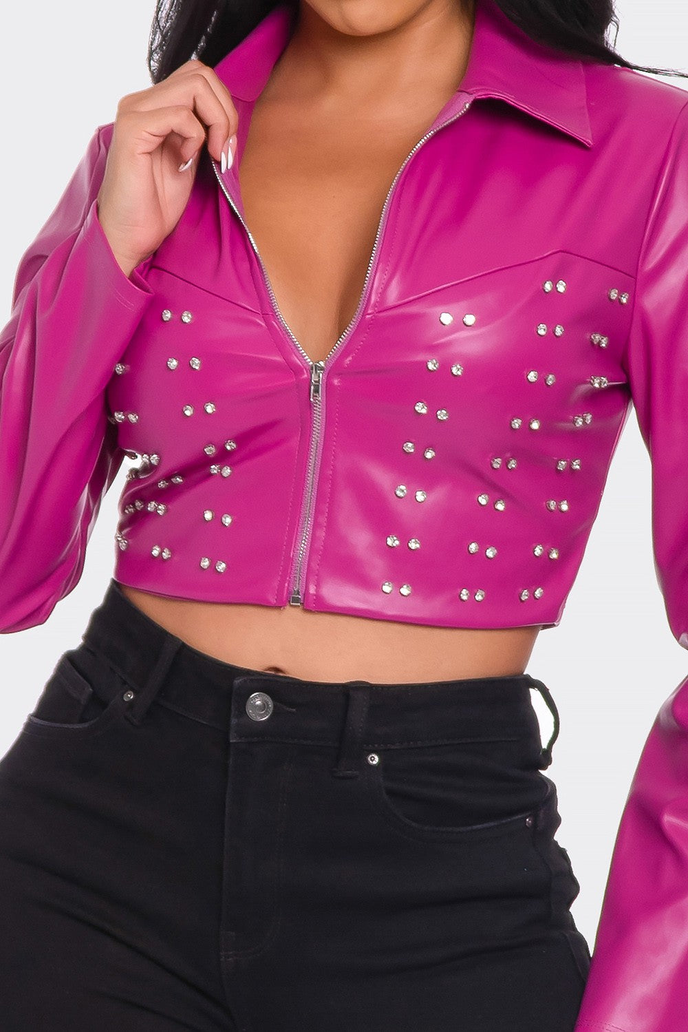 a woman wearing a pink leather jacket and black pants