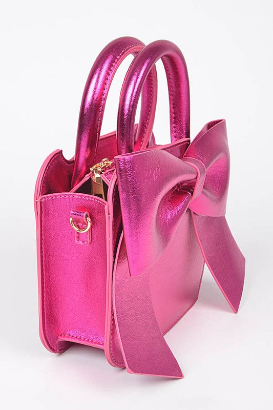 a pink purse with a large bow on it