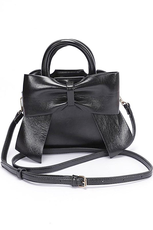 a black handbag with a bow on the front