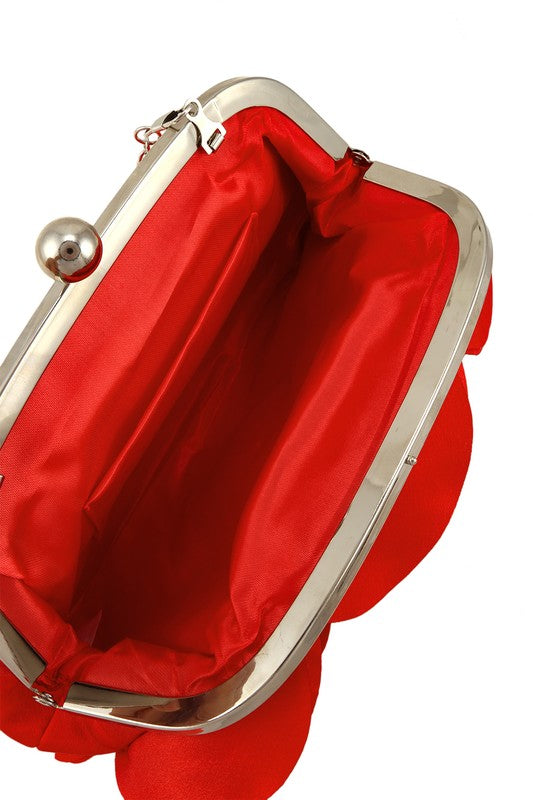 a red purse with a silver handle and a red satin lining