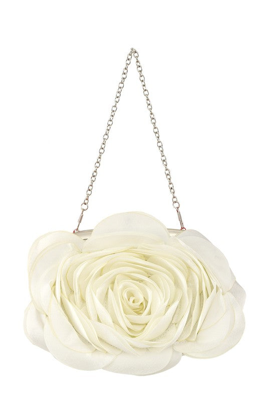 a white flower purse hanging from a chain