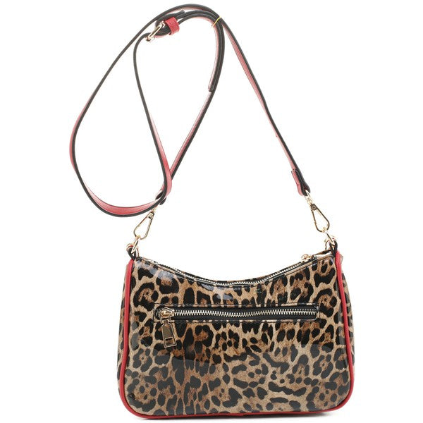 a leopard print purse with a red strap