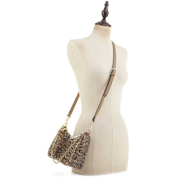 a white mannequin holding a leopard print purse