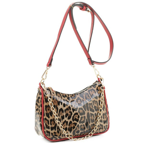 a leopard print purse with a red strap