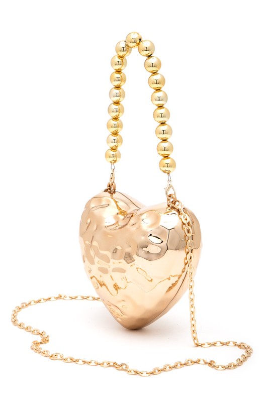 a gold heart shaped purse with a chain