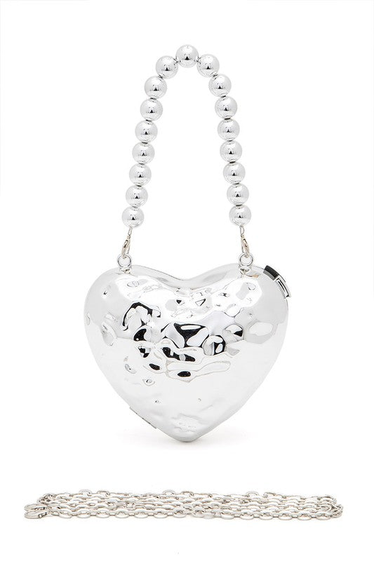 a heart shaped purse with a chain attached to it