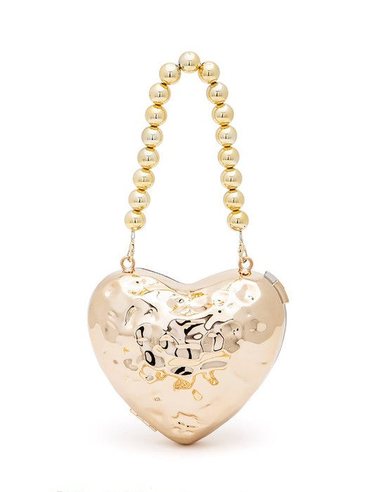 a gold heart shaped purse with a beaded handle