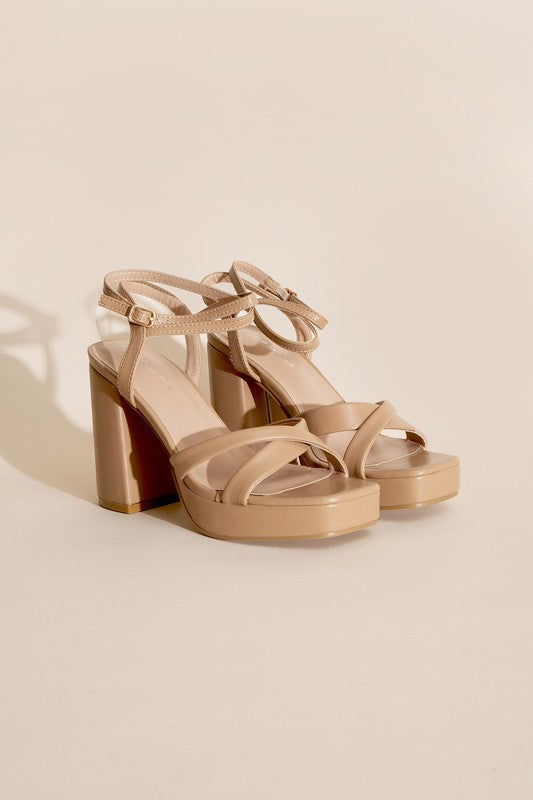 a pair of nude colored high heel sandals