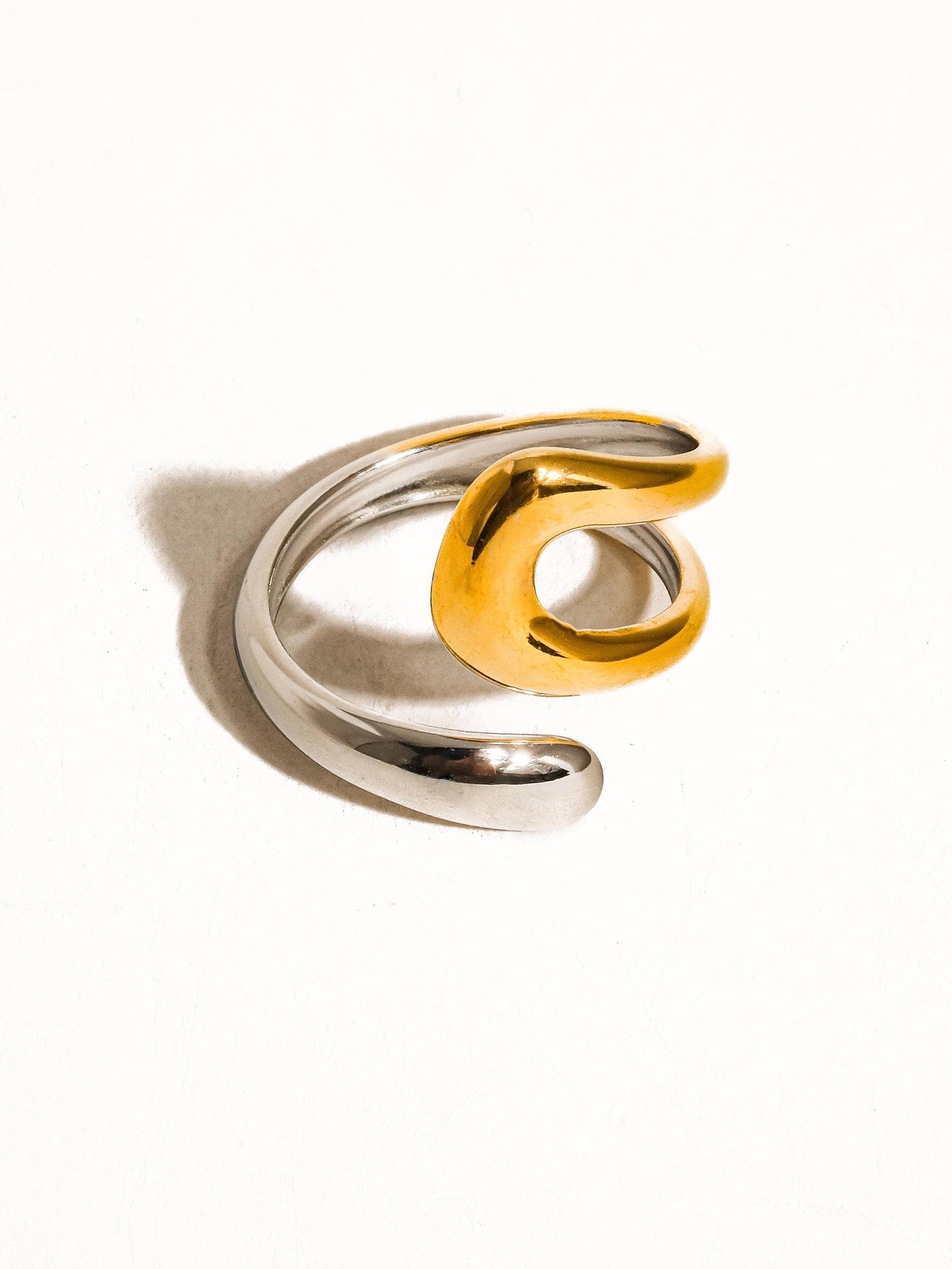 a gold and silver ring on a white background