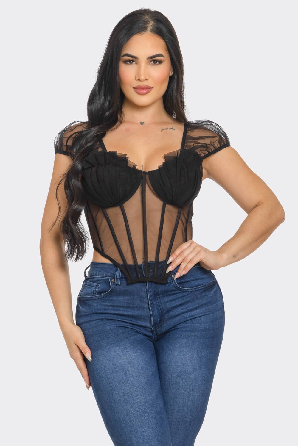 a woman wearing a black top and jeans