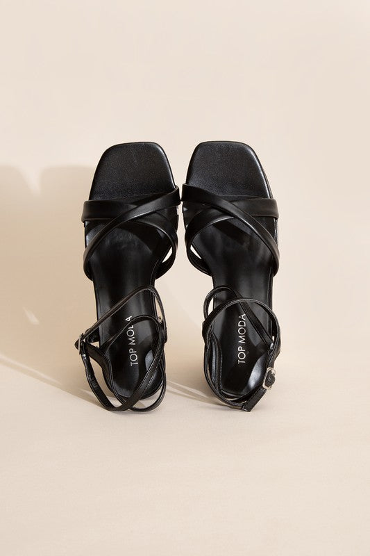 a pair of black high heeled sandals