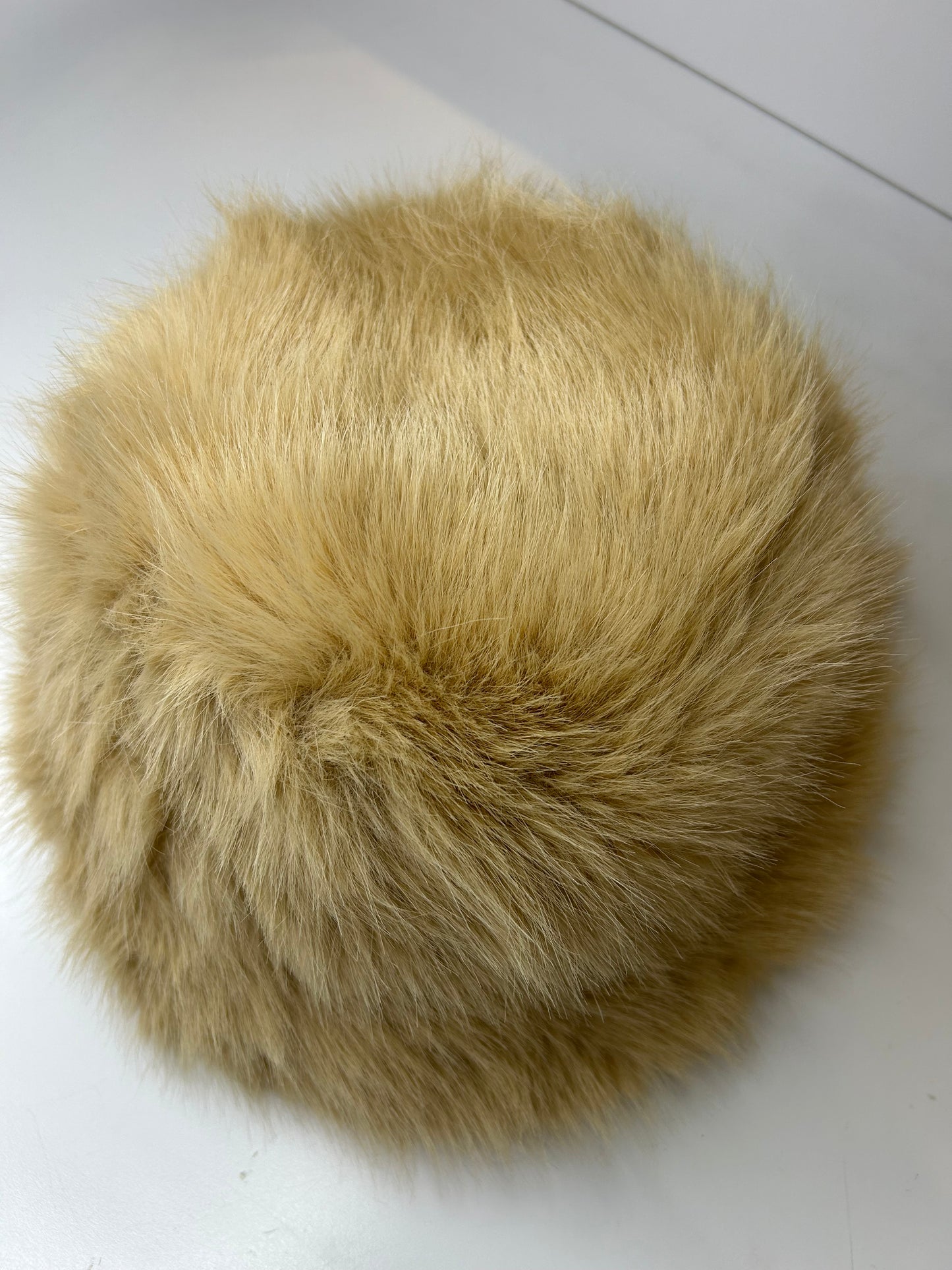 a close up of a fur ball on a white surface