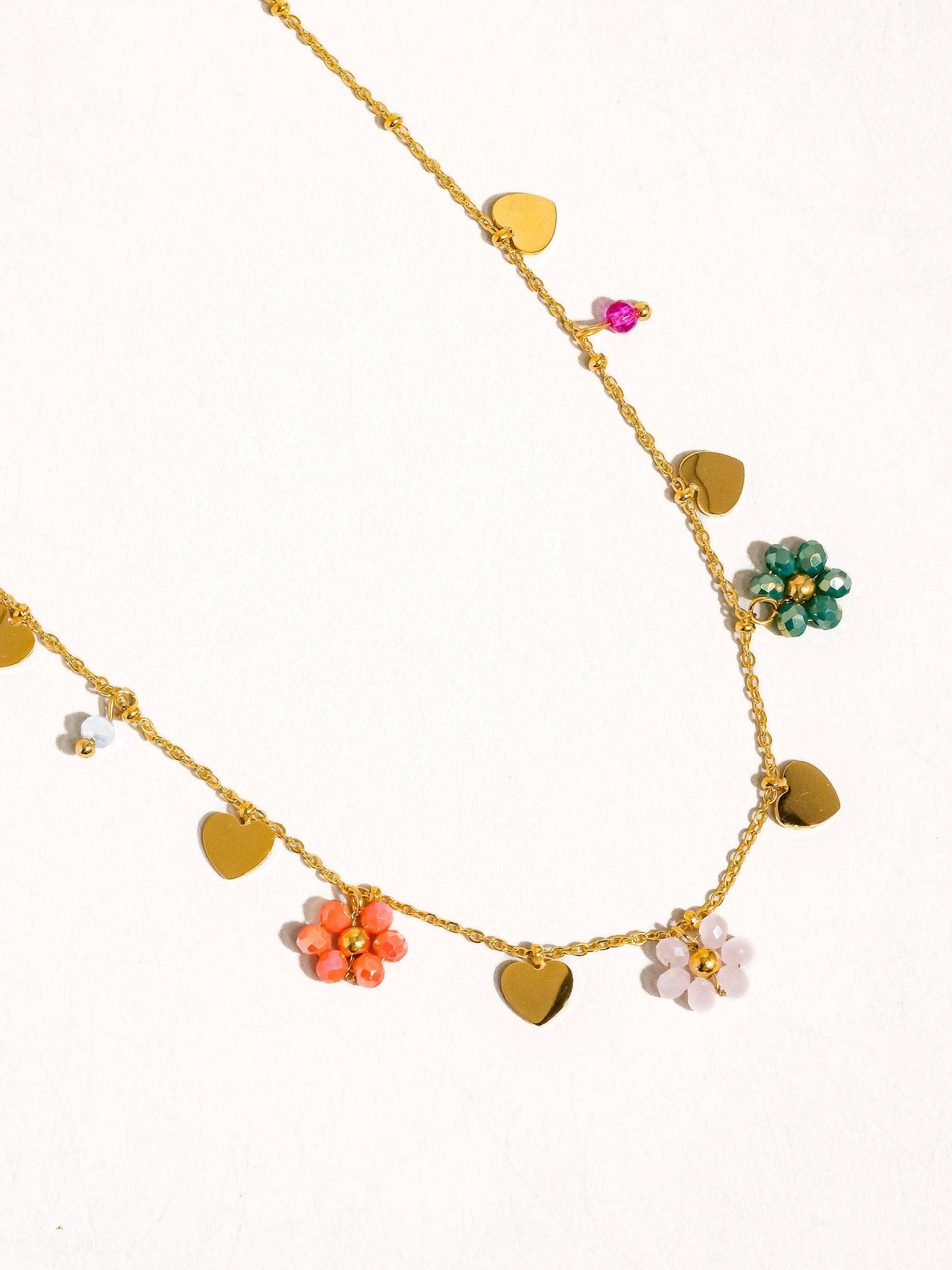 a gold chain with hearts and flowers on it