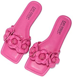 a pair of pink sandals with flowers on them