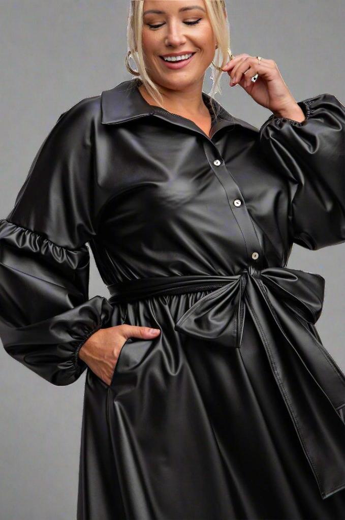 a woman wearing a black leather dress