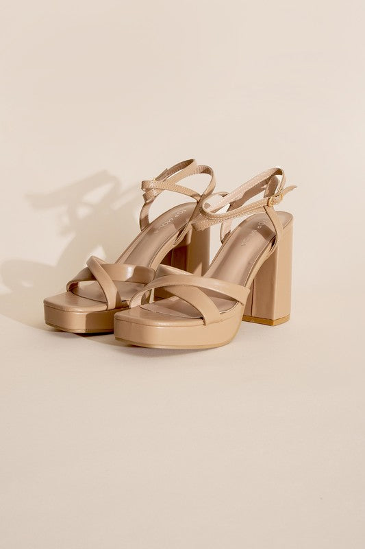 a pair of nude colored high heel sandals