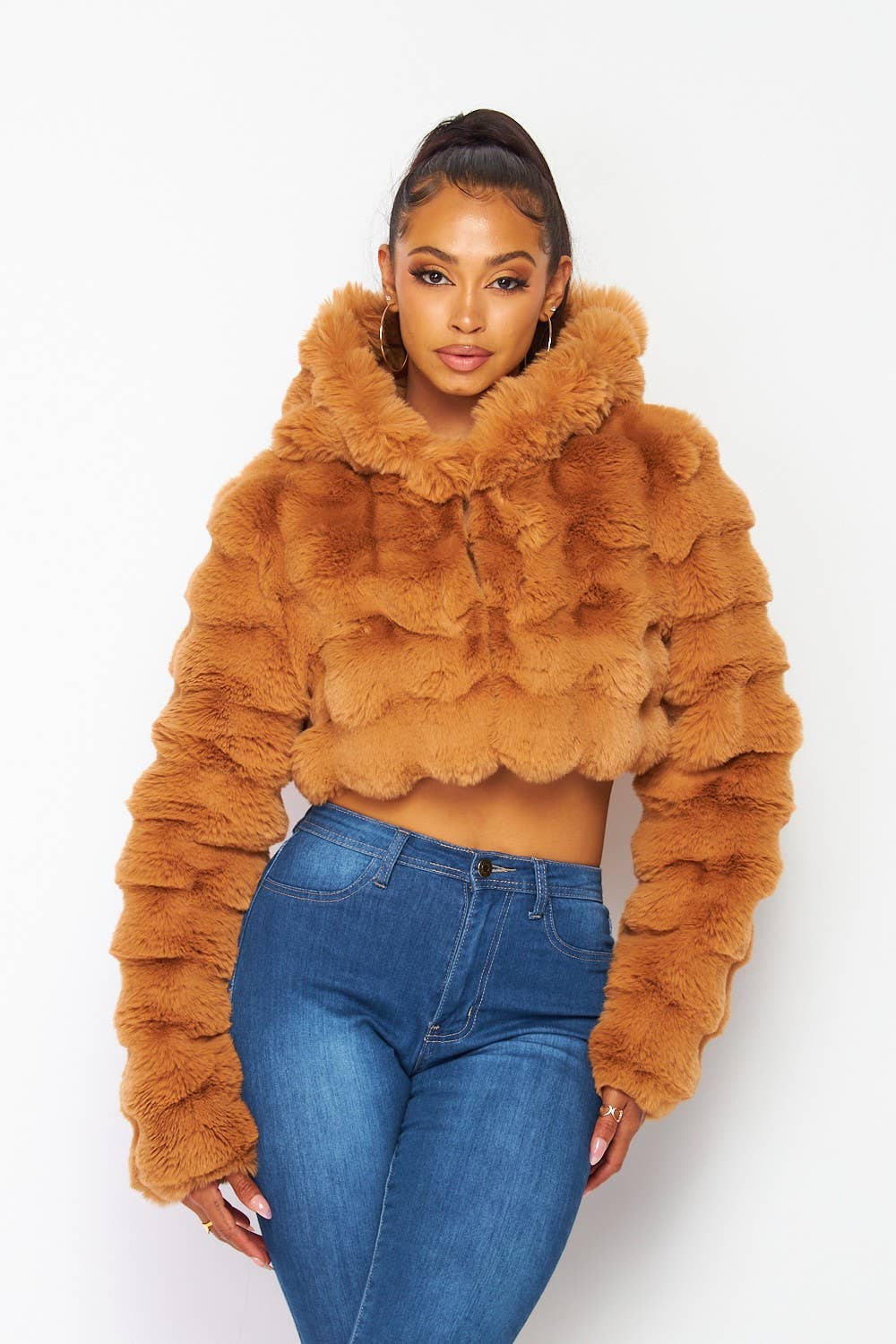 a woman in jeans and a fur coat