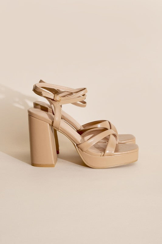 a pair of nude colored high heel sandals