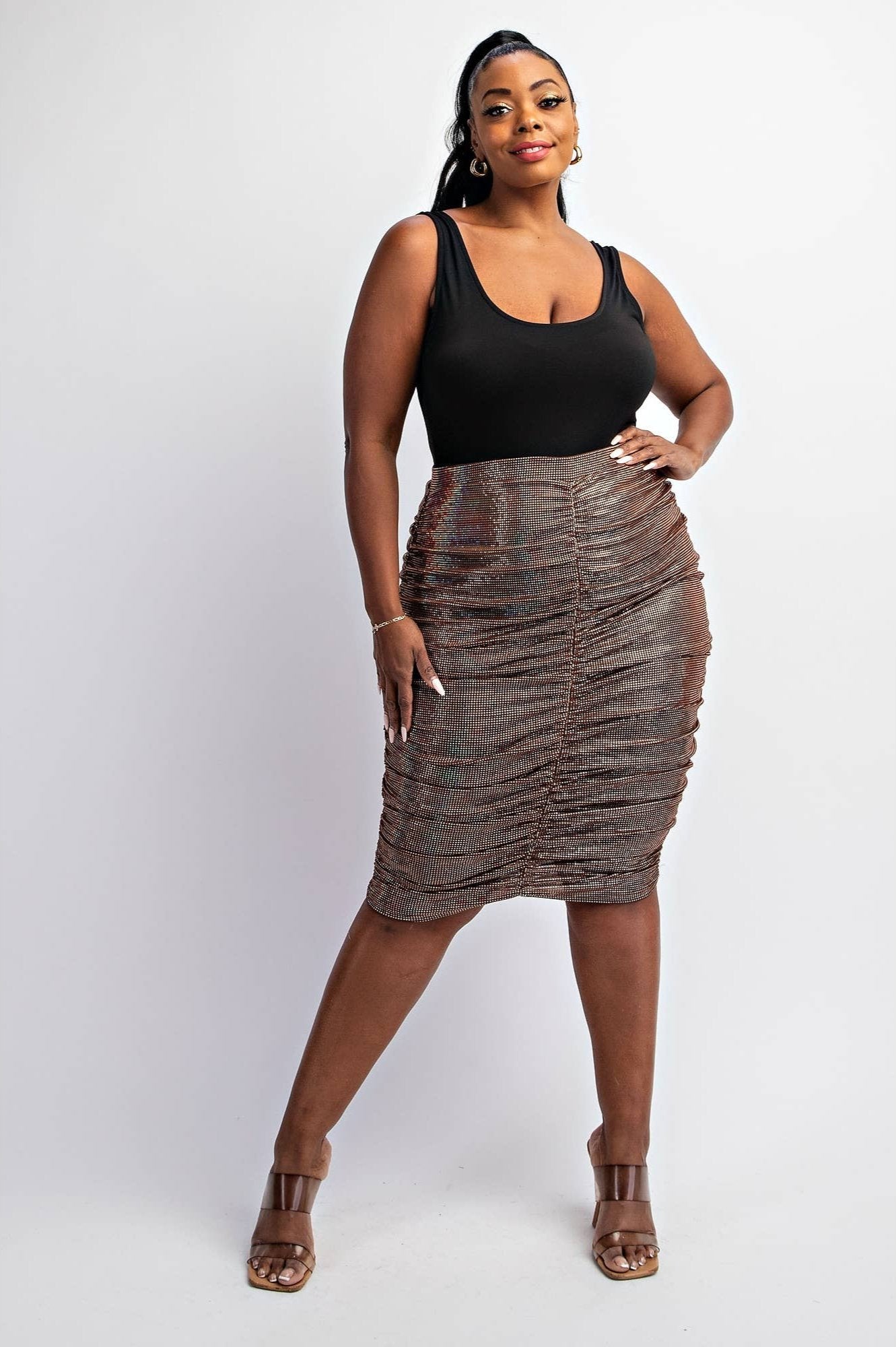 a woman in a black top and brown skirt