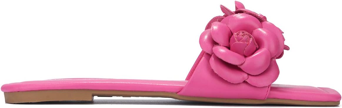 a pair of pink shoes with a flower on the heel