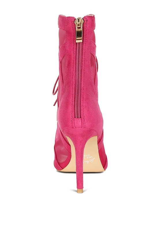 a pink high heeled shoe with a zipper