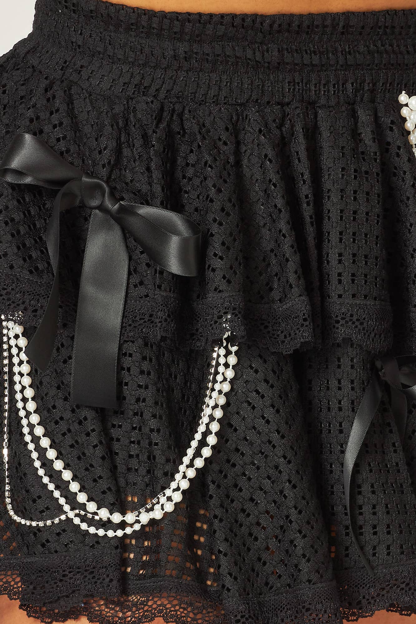 a close up of a skirt with pearls on it