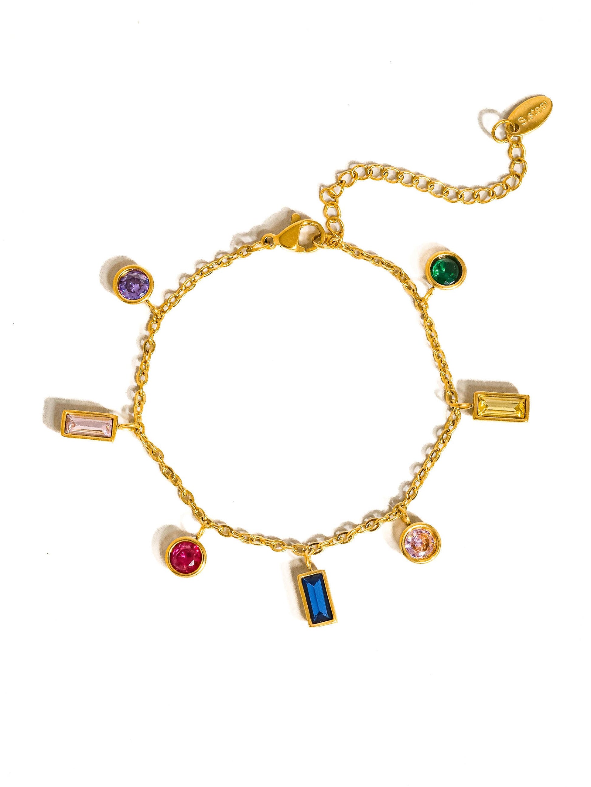 a gold bracelet with different colored stones