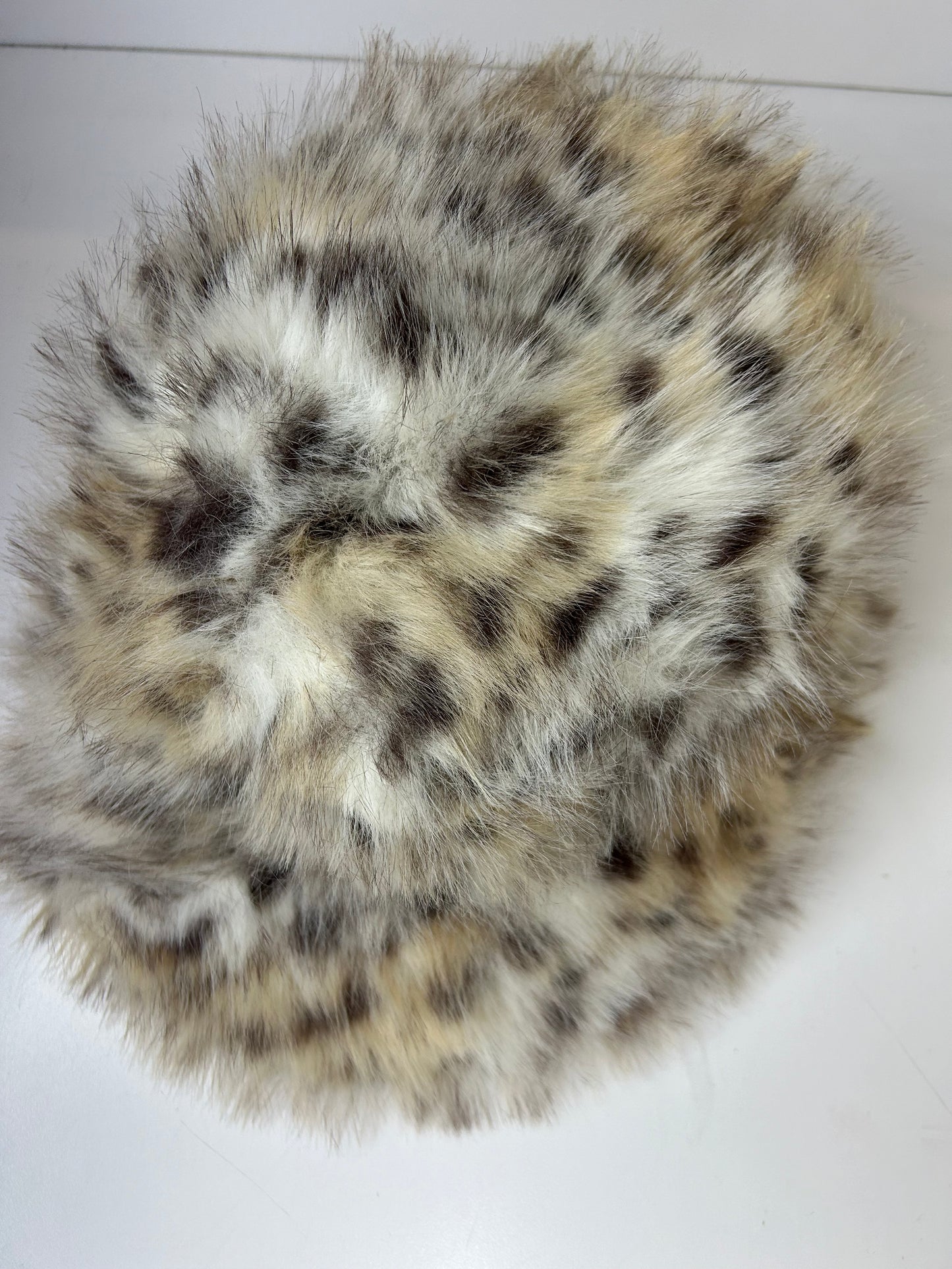 a close up of a fur ball on a white surface