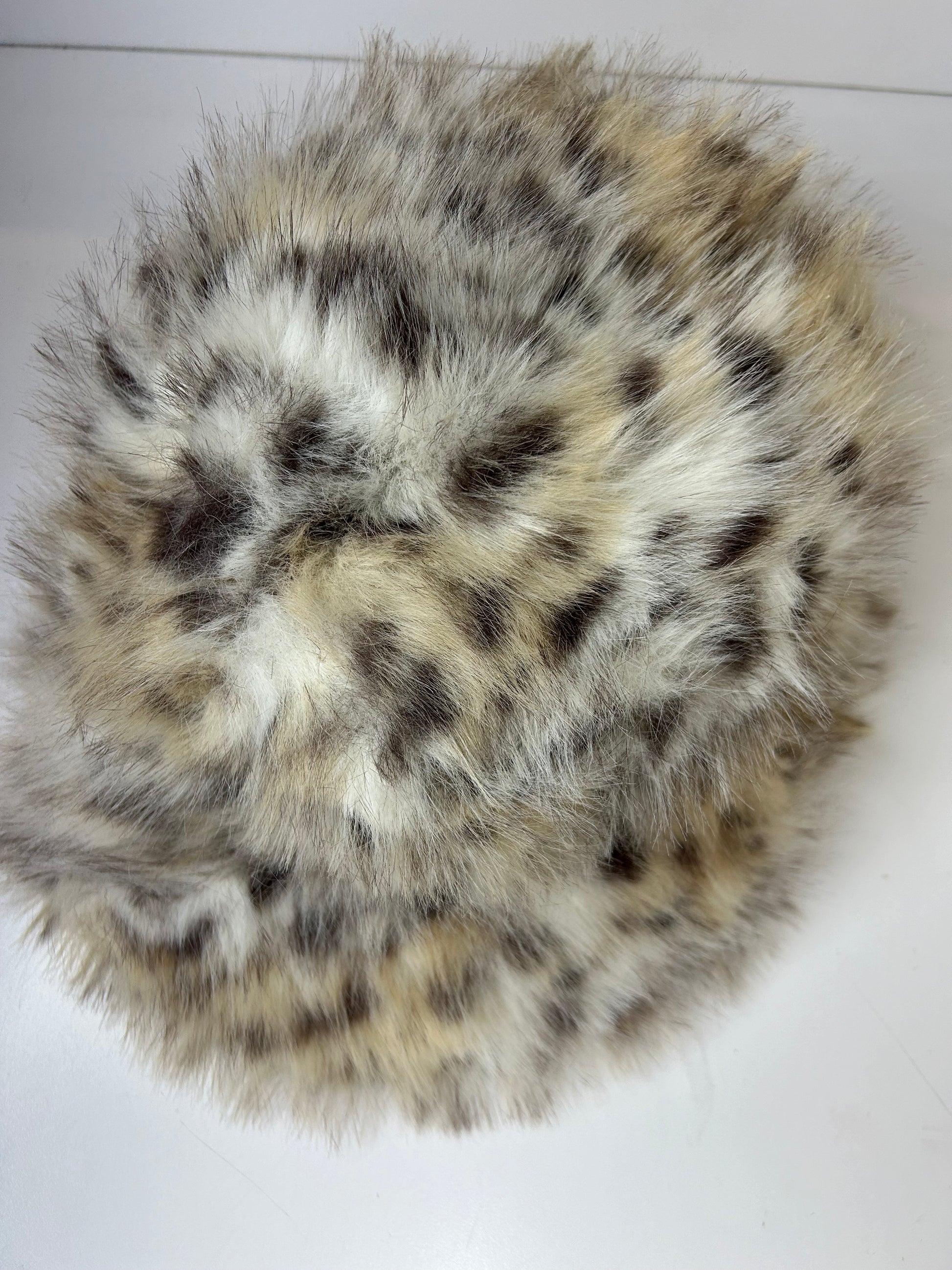 a close up of a fur ball on a white surface