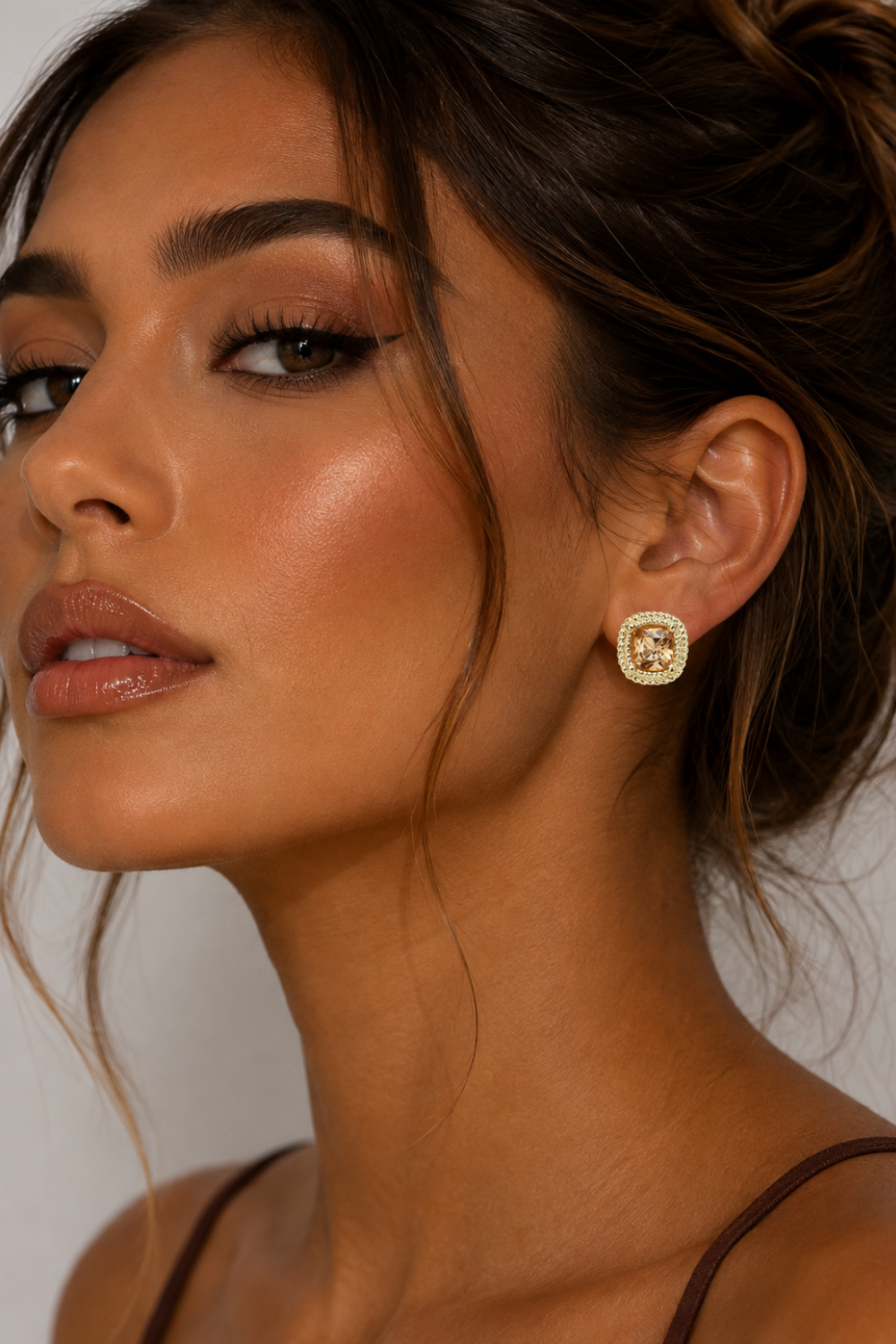 Model wearing Champagne Crystal Gold Rope Stud Earrings featuring sparkling cushion-cut cubic zirconia stones in a 14K gold-plated rope setting for an elegant, timeless look.