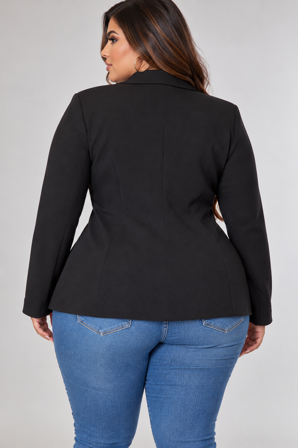 Back view of the Zoe plus-size black tailored blazer showing its structured shoulders, smooth tailored back, fitted waist, and long sleeves.