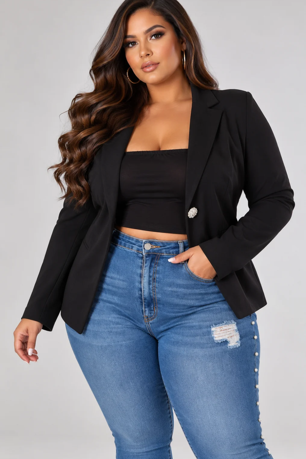 Plus-size model wearing the Zoe black tailored blazer featuring notched lapels, a pearl-and-crystal embellished statement button, and a single-breasted silhouette.