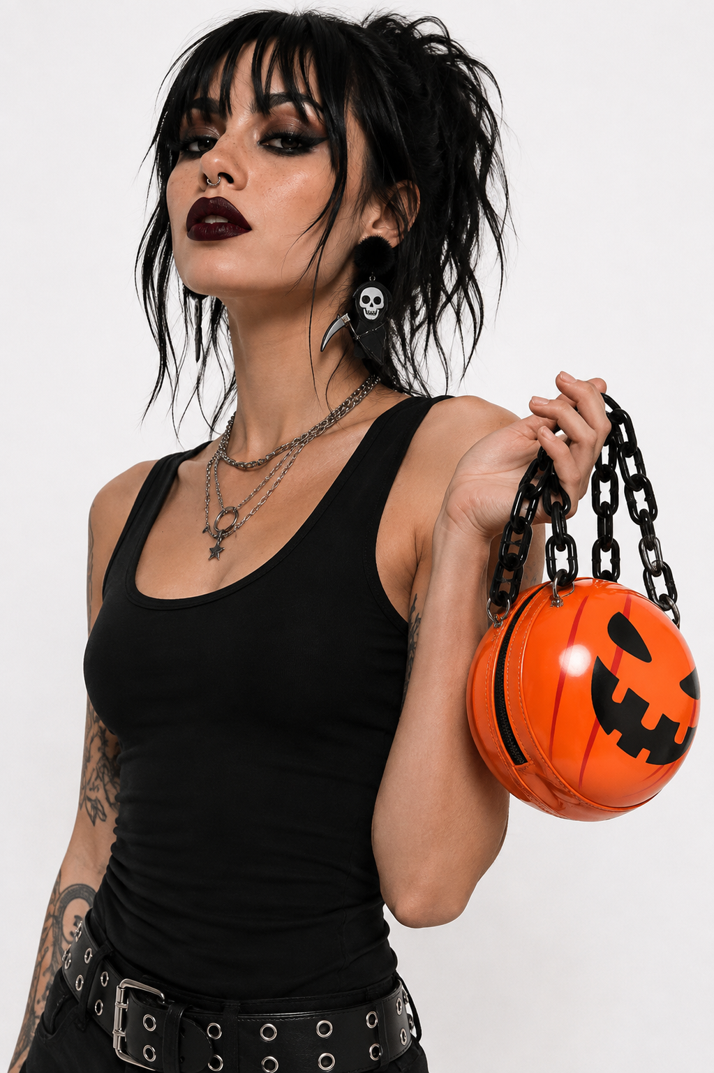 Orange Halloween pumpkin jack-o'-lantern crossbody handbag with chunky black chain strap.