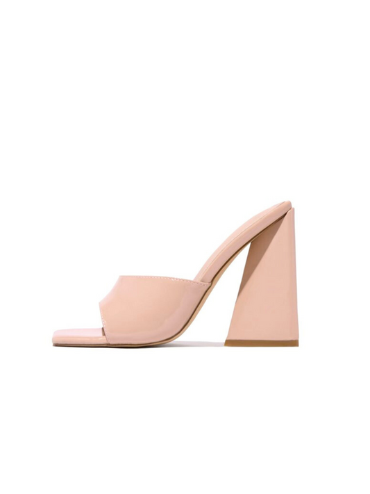 a pair of nude colored shoes on a white background