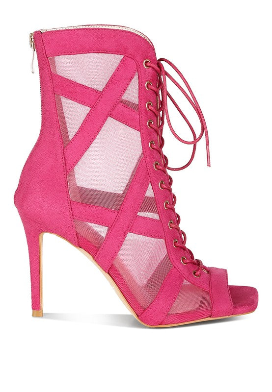 a pink high heeled shoe with a caged design