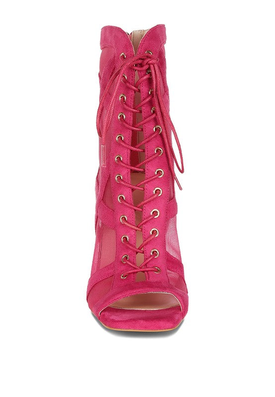 a pink high heeled shoe with laces